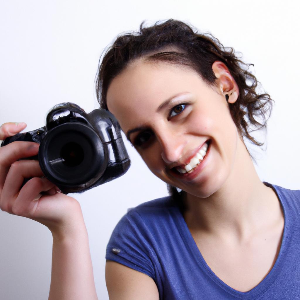 Person holding a camera, smiling